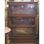 A Globe-Wernicke and Co Limited three-tier bookcase with shaped top, up-and-over glazed doors with