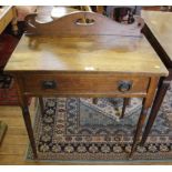 An Arts and Crafts oak stained occasional table with carved back, one drawer under with metal drop