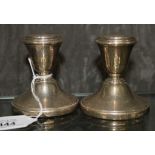 A pair of miniature silver candle sticks