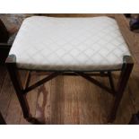 An early 20th century oak framed oblong dressing stool with upholstered seat and stretcher supports