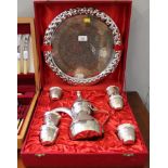 A Middle Eastern-style silver plated with copper tea service, comprising tea pot, tray and six