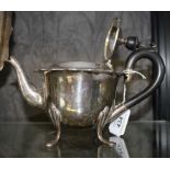A silver tea pot on four pad feet, having wooden handle and knob, London 1919, 368.5 g