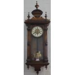 A 19th century-style walnut framed Viennese wall clock with six turned finials, elaborately carved