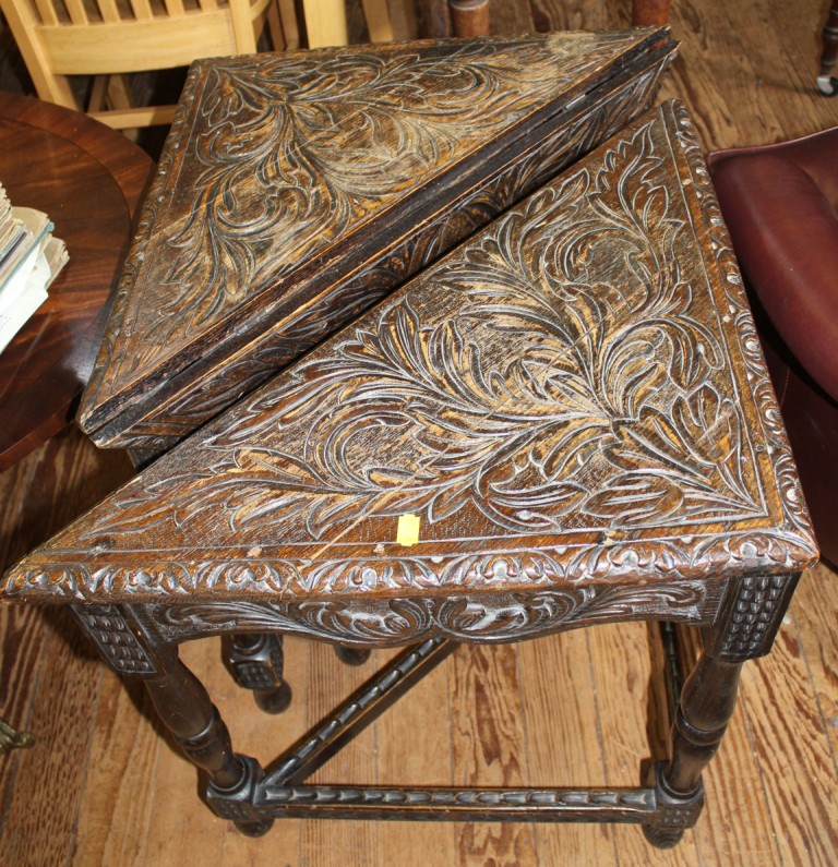 A pair of oak stained Arts and Crafts square drop leaf tables with incised carving to the top,