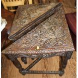 A pair of oak stained Arts and Crafts square drop leaf tables with incised carving to the top,