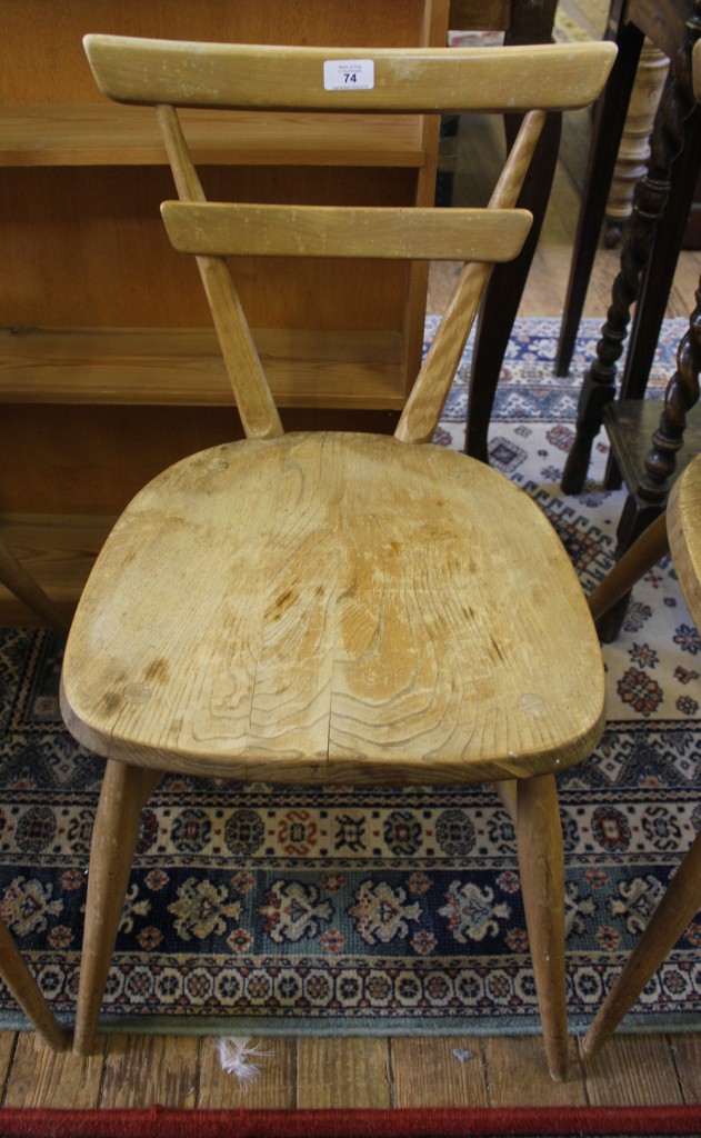 A set of four vintage Ercol stacking chairs with 'V' shaped supports, dished seats raised on splayed