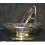 A small silver swing handle basket with pierced and rivet decoration on relief, London 1873, 152 g
