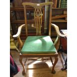 An early 20th century mahogany Chippendale-style carver armchair with shaped top rail, urn-shaped