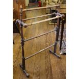 An Edwardian stained pine towel holder on trestle supports