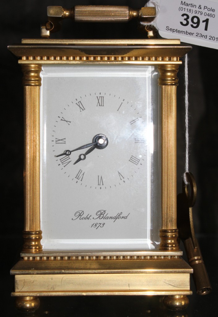 A brass French carriage clock by Robert Blandford, 1873 with Roman numerals and swing handle, 12cm