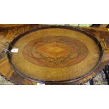 An Edwardian mahogany and walnut oval shaped serving tray with wavy rim galleried border, twin brass