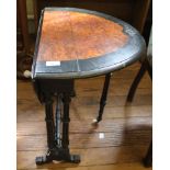 An Edwardian walnut and ebonised Sutherland table with incised carving to the top, twin drop leaves,