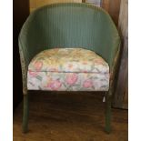 A mid 20th century green-painted Lloyd Loom-style occasional chair with fabric upholstered removable