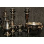 An assortment of silver plated table ware to include a pair of candlesticks, sugar shaker, cruet set