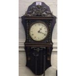 A 19th century style brass mounted wall clock with profuse carving and fret work to the cornice