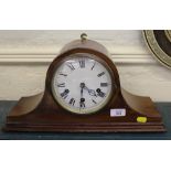 An Edwardian mahogany dome-shaped mantle clock with Roman numerals raised on a stepped base