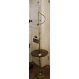 A Victorian-style brass framed floor lamp with adjustable arm and circular mahogany platform shelf