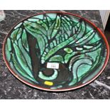 A mid-20th century Poole Pottery charger, hand-painted by Carole Lynn Beckwith, both with multi-