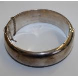 A silver bangle with incised decoration