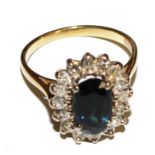 A lady's diamond and sapphire cluster ring