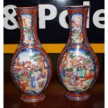 A pair of late 18th century Cantonese multi-coloured bottle vases with allegorical scenes, each 29cm