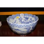 An early 19th century Chinese blue and white lobed circular centre bowl with wavy rim on a single