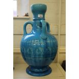 A pair of Burmantofts turquoise three-handled baluster shaped vases with flared rims with abstract