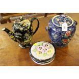 A multi-coloured ceramic biscuit barrel with floral depictions, hand painted dish with lid,