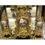 A 19th century French clock garniture with elaborate ormolu carving and fret work, circular