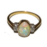 An opal and diamond ring set in tested 18 carat gold