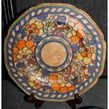 A Charlotte Rhead for Crown Ducal circular dish with multi-coloured floral and foliate designs,