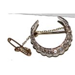 An Edwardian diamond-set crescent brooch