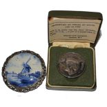 A silver medallion commemorating the investiture of the Prince of Wales, together with a Delft