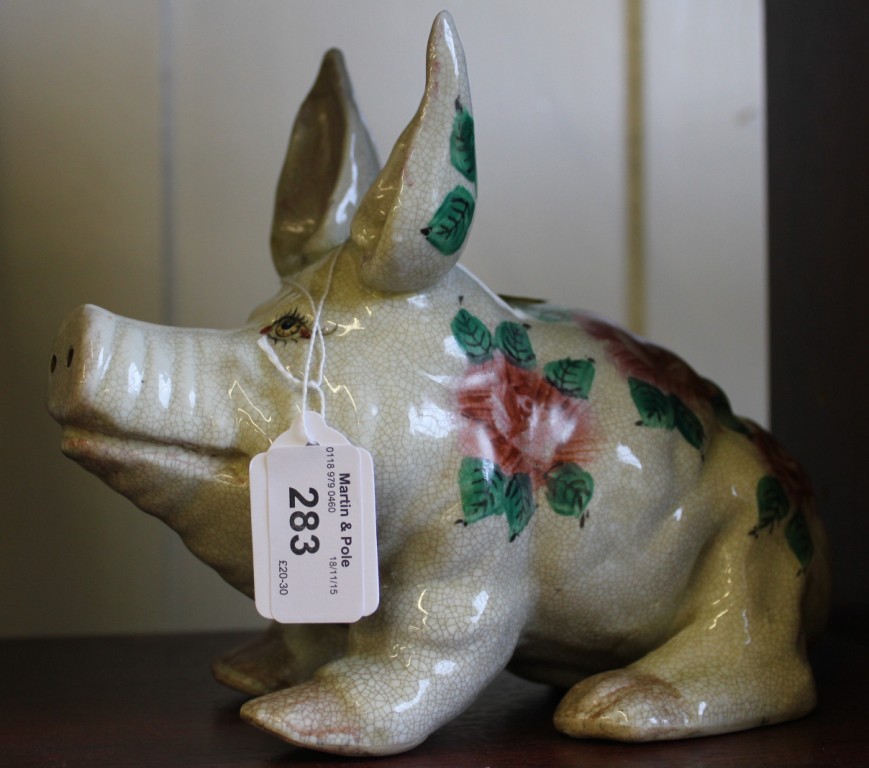 A Wemyss style pig, decorated in pink roses and green leaves. 23cm long