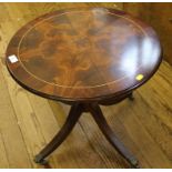 A Georgian-style mahogany circular occasional table with string inlay to top on a quadruped base,