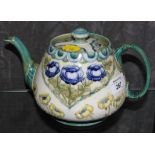 A James Macintyre teapot designed by William Moorcroft with typical floral decoration in shades of