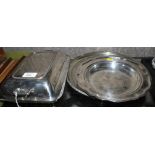 A large round silver plated tray with incised decoration, a silver plated entree dish together