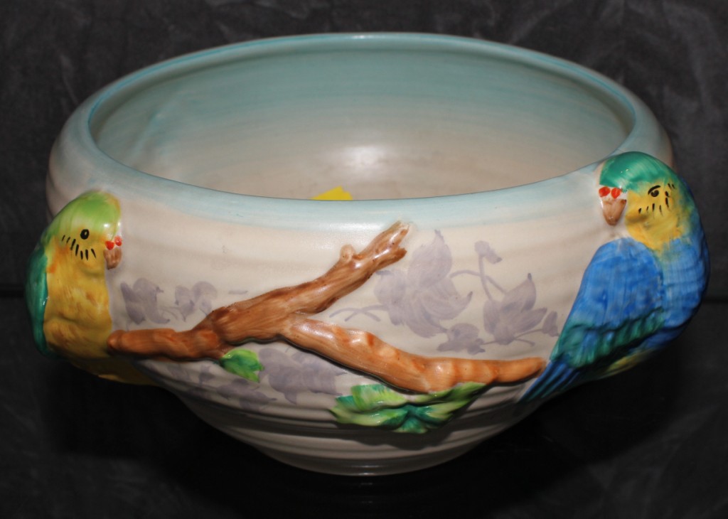 A Clarice Cliff Newport pottery bowl, decorated in relief with budgerigars sitting on a branch, 21cm