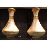 A pair of Royal Worcester pear-shaped ivory ground vases with waisted necks, puce marks