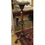 An early 20th century jardiniere stand, carved feet, centre column and neck, 107cm high