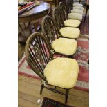 Set of four spindle-back oak kitchen chairs on turned legs and stretcher supports