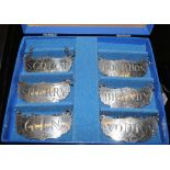 A box set of six Steiff pewter decanter labels, scotch, bourbon, sherry, brandy, gin and vodka