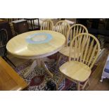 A circular dining table with four matching chairs, 107 diameter