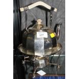 A silver plated kettle and burner