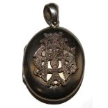 A silver locket with applied initials