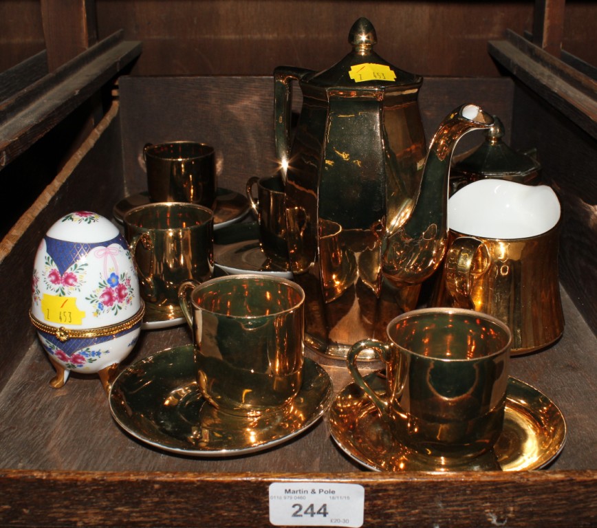 A Japanese porcelain gold finish coffee set and a porcelain egg