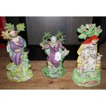 A pair of mid 19th century Staffordshire figures depicting Elijah and his wife, plus another