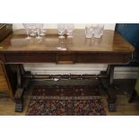 An early 19th century mahogany oblong library table with shaped top, two frieze drawers, raised on