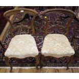 A pair of Victorian dining chairs with fabric upholstered seats