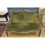 A Victorian mahogany framed two-seat sofa with fabric upholstery to the support, arms and serpentine